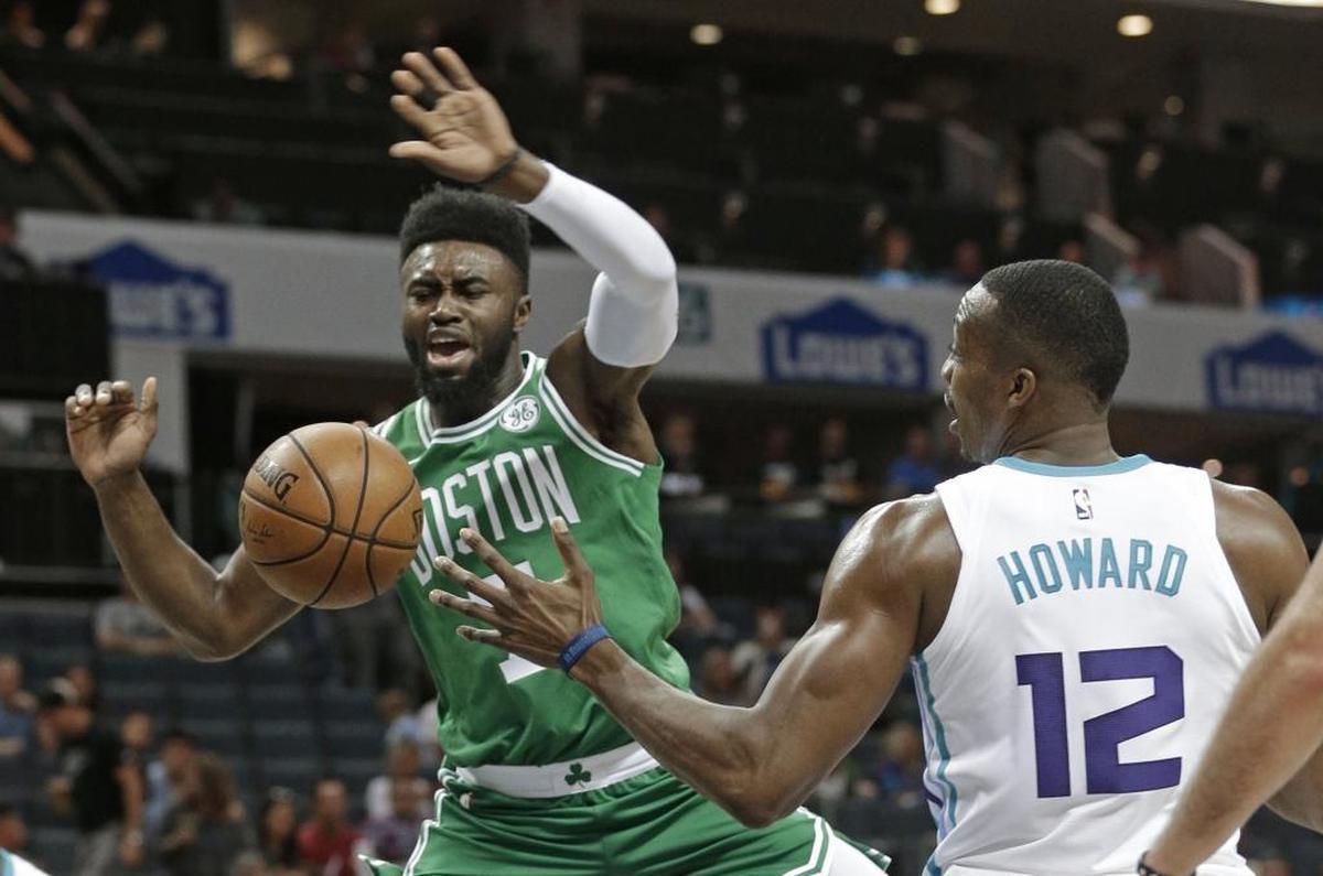 The Hornets’ Dwight Howard fouls Jaylen Brown in the first half Wednesday against Boston at the Spectrum Center in Charlotte.