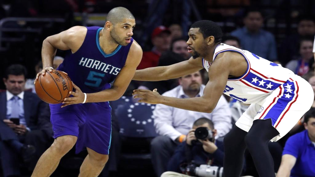 Charlotte Hornets' Nicolas Batum, left, tries to dribble past Philadelphia 76ers' Hollis Thompson during the second half of an NBA basketball game, Tuesday, March 29, 2016, in Philadelphia. Charlotte won 100-85.
