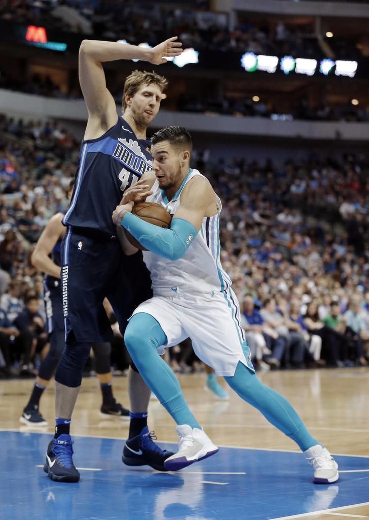 Charlotte Hornets forward Willy Hernangomez (41), right, battles Dallas Mavericks forward Dirk Nowitzki (41) for space during Saturday’s game. Hernangomez scored three points and pulled down seven rebounds in 14 minutes of playing time.