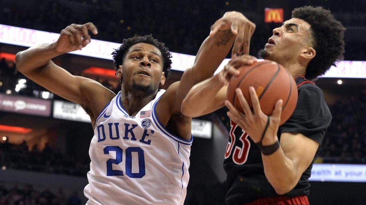 Duke center Marques Bolden (20) and Louisville forward Jordan Nwora (33) vie for a rebound during the first half of an NCAA college basketball game in Louisville, Ky., Tuesday, Feb. 12, 2019. (AP Photo/Timothy D. Easley)