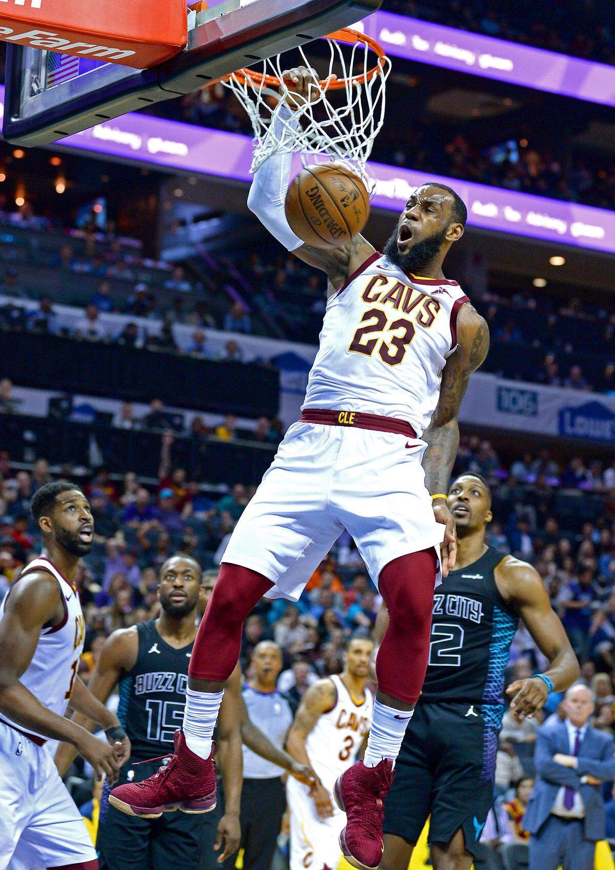 Cleveland Cavaliers forward LeBron James throws down a one-handed dunk against the Charlotte Hornets during third quarter action on Wednesday, March 28, 2018 at the Spectrum Center in Charlotte, NC.