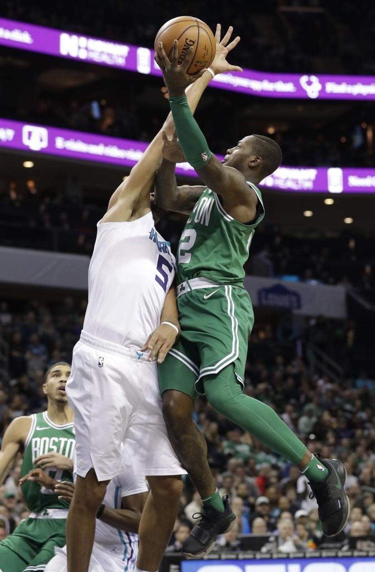 Boston Celtics guard Terry Rozier (12) shoots over Charlotte Hornets guard/forward Nicolas Batum (5). Asked if the Celtics took away his aggressiveness on Wednesday, Batum said “I understand sometimes you have to go with the flow.”