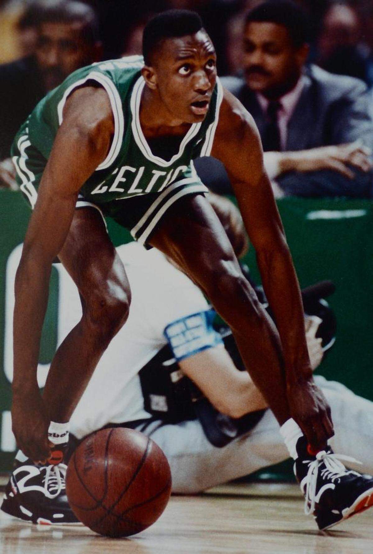 Boston Celtics guard Dee Brown pumps up his Reebok Pump sneakers prior to performing a dunk during the 1991 NBA Slam Dunk Contest at the Charlotte Coliseum in Charlotte, NC. Brown would win the contest.