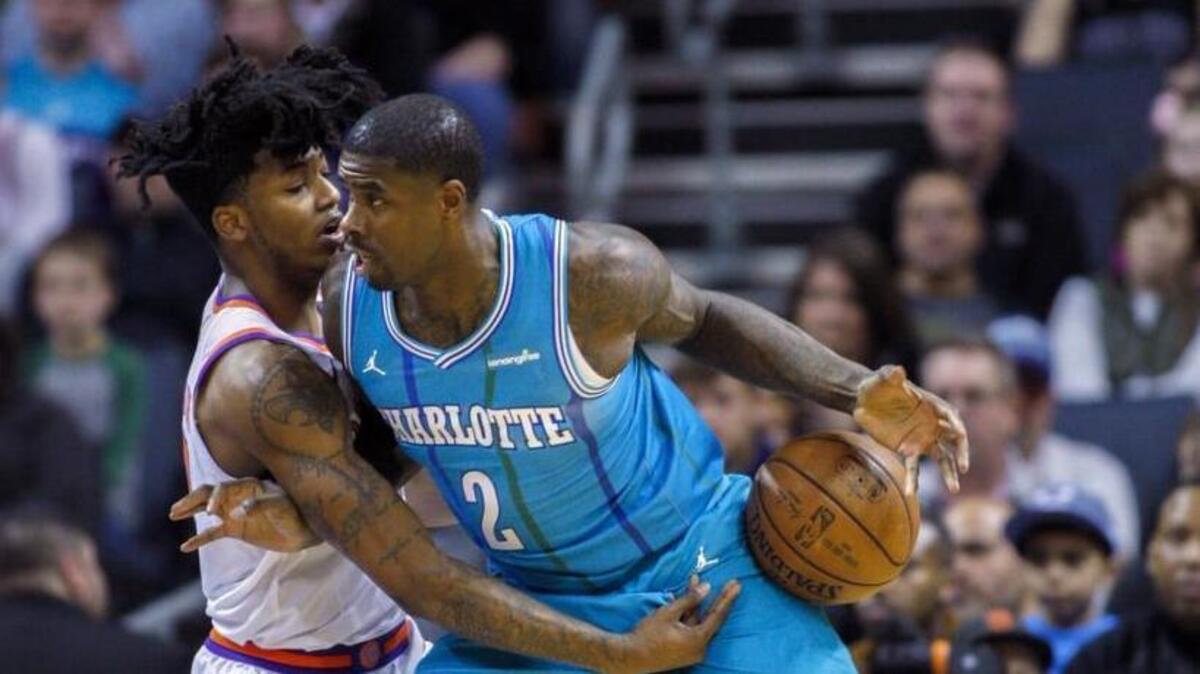 Charlotte Hornets forward Marvin Williams, right, drives into Phoenix Suns guard Elfrid Payton in the first half of Saturday’s game.