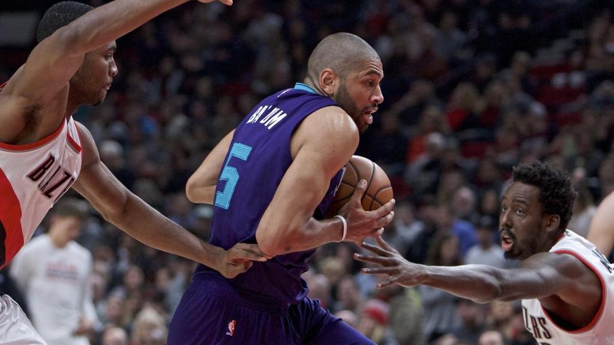 Charlotte Hornets guard Nicolas Batum, center, drives on his former team during Tuesday’s game against the Portland Trail Blazers.
