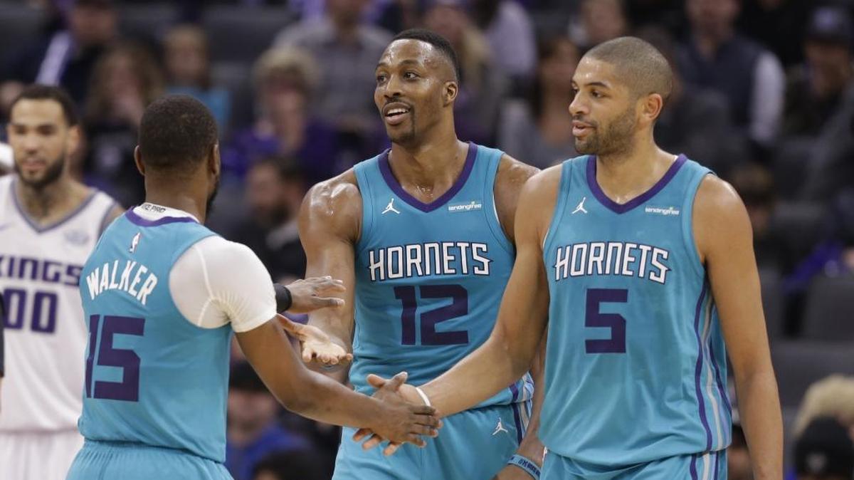 Nic Batum (right) and Dwight Howard (center) had to trust each other on the court for the Charlotte Hornets to have any hope of making the playoffs. Now they are, and the team is on a five-game winning streak.