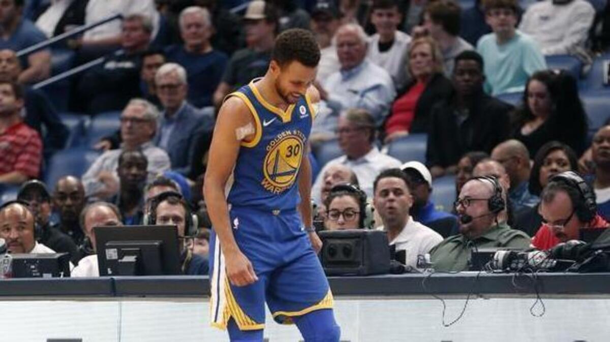 Golden State Warriors guard Stephen Curry limps off the court to the locker room in the second half of Monday’s NBA game at New Orleans.