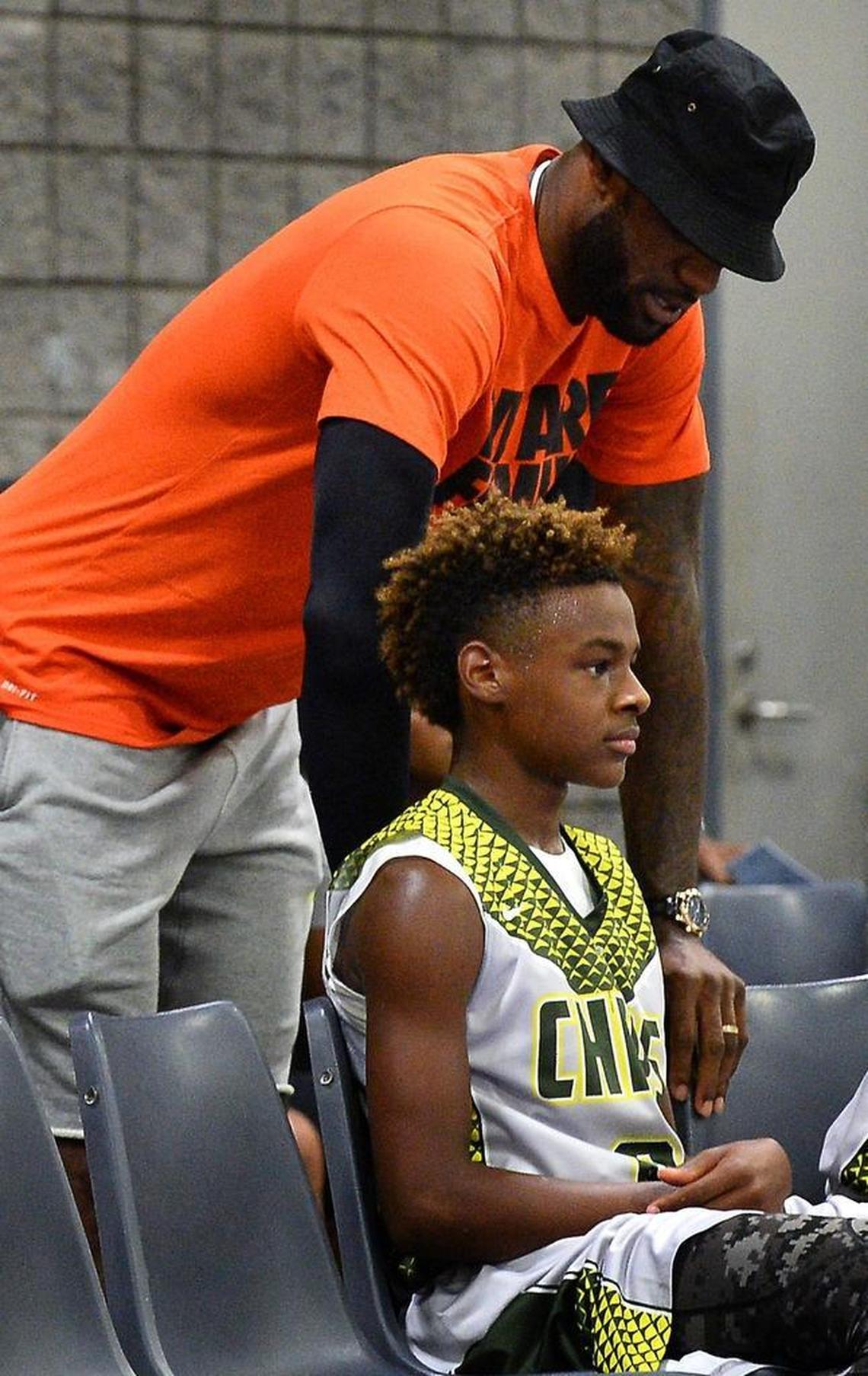 NBA star LeBron James checks on his son, LeBron James Jr., who suffered a minor injury in the fourth quarter during a game in the United States Basketball Association National Tournament at the Charlotte Convention Center Friday. LeBron Jr. plays for the North Coast Blue Chips (Ohio).