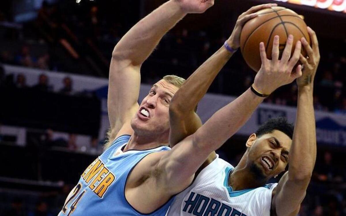 Charlotte Hornets guard Jeremy Lamb, right, rips a rebound away from Denver Nuggets forward/center Mason Plumlee, left, during the second half of Friday’s 122-114 win against the Denver Nuggets.