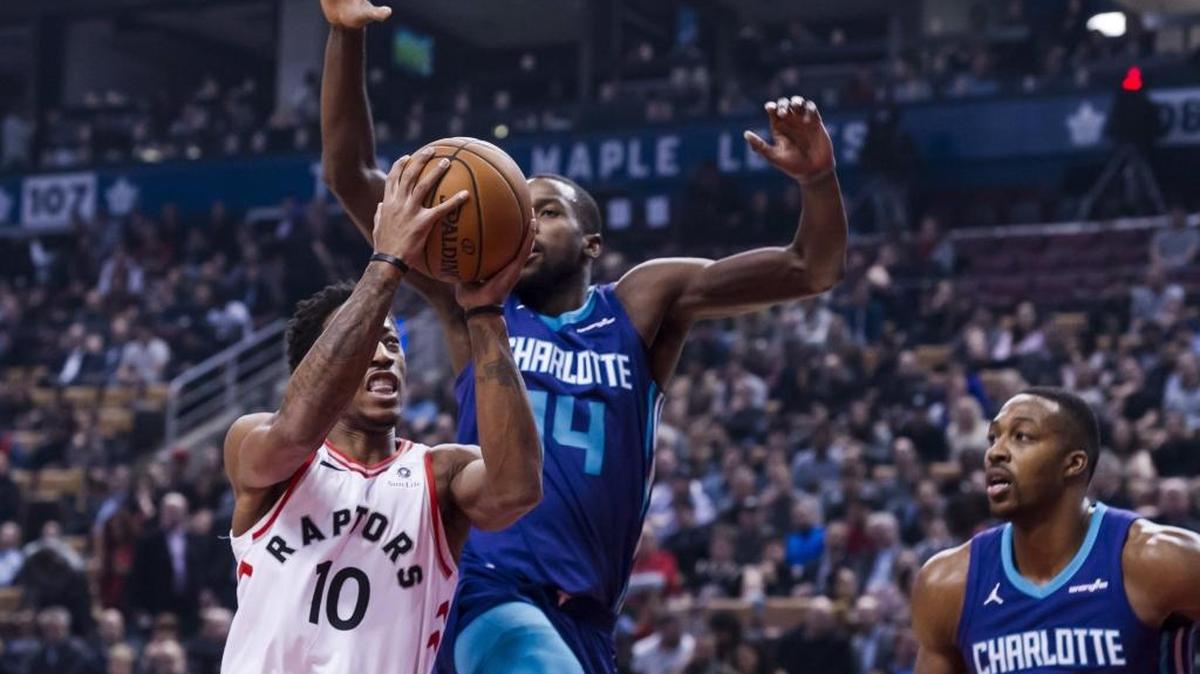 Toronto Raptors guard DeMar DeRozan (10) drives on Charlotte Hornets forward Michael Kidd-Gilchrist (14) Wednesday at Air Canada Centre.