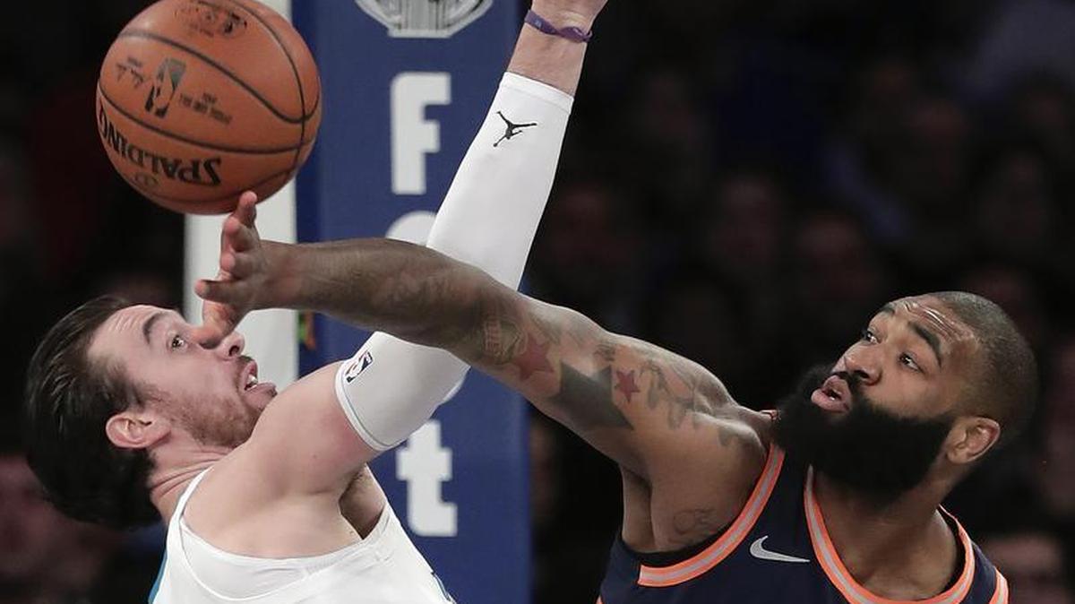Charlotte Hornets forward Frank Kaminsky, left, and New York Knicks center Kyle O'Quinn (9) battle for a rebound during the second quarter of Saturday’s game. Five New York players scored in double figures in its highest scoring game of the season.