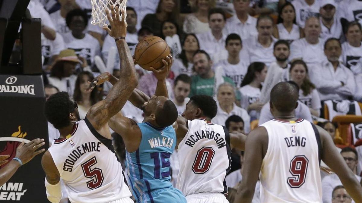 Charlotte Hornets guard Kemba Walker (15) is fouled as he goes to the basket by Miami Heat guard Josh Richardson (0) during the first half of Wednesday’s game.