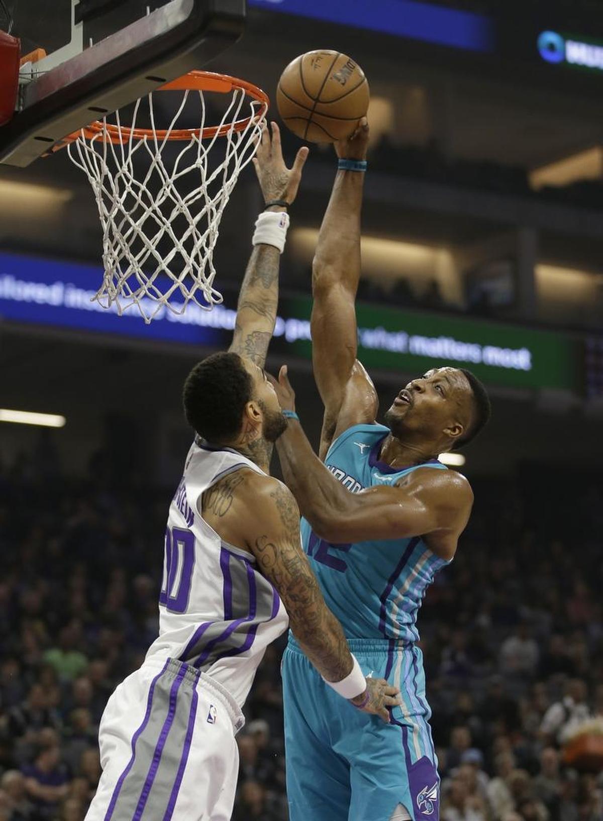 Charlotte Hornets center Dwight Howard, right, goes to the basket against Sacramento Kings center Willie Cauley-Stein during Tuesday’s NBA game in Sacramento, Calif. Howard had 20 points and eight rebounds in the Hornets’ 131-111 victory.