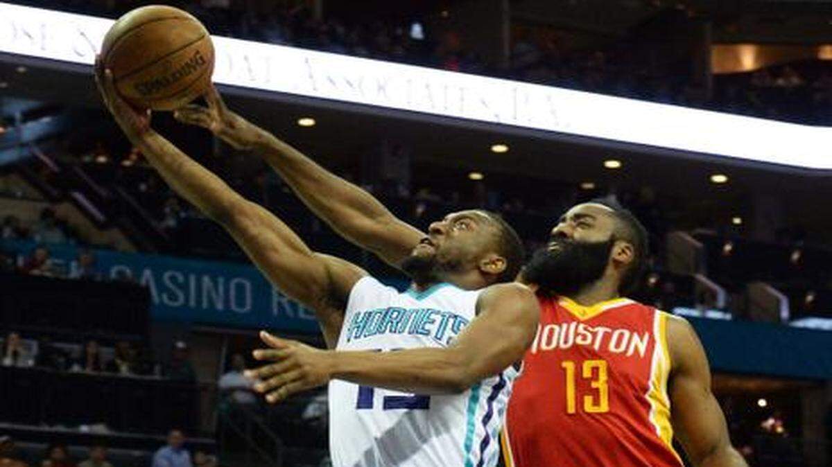 
Charlotte Hornets Kemba Walker (left),carries the ball to the basket against Houston Rockets James Harden (right), during Monday night's game played at Time Warner Cable Arena, April 13, 2015.
