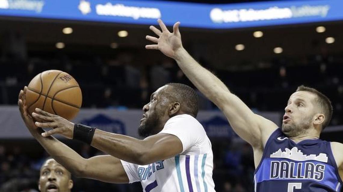 Charlotte Hornets' Kemba Walker (15) drives past Dallas Mavericks' J.J. Barea (5) during the first half of Wednesday’s game at Spectrum Center.