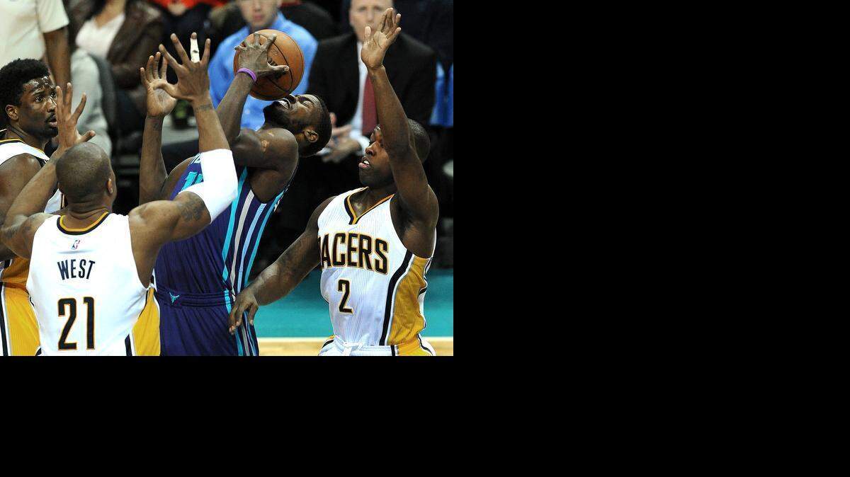 
Charlotte Hornets forward Michael Kidd-Gilchrist, center, fights to maintain control of the ball as he is surrounded by Indiana Pacers defenders at Time Warner Cable Arena in Charlotte,  Jan. 17, 2015.
