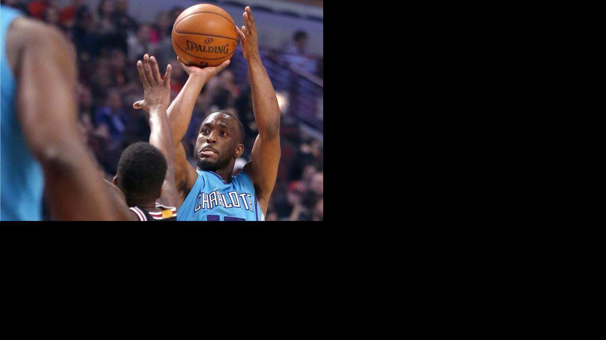 
Charlotte Hornets guard Kemba Walker (15) shoots over Chicago Bulls guard Aaron Brooks, Monday, March 23, 2015, in Chicago.
