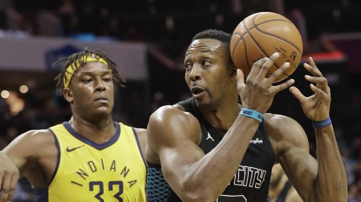Charlotte Hornets' Dwight Howard (12) drives against Indiana Pacers' Myles Turner (33) during the first half of Friday’s game at Spectrum Center.