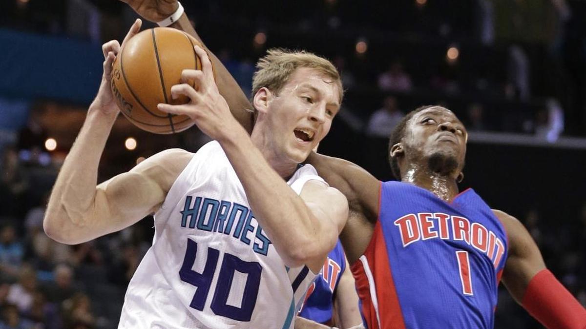 Charlotte Hornets' Cody Zeller (40) grabs a rebound in front of Detroit Pistons' Reggie Jackson (1) in the first half of an NBA basketball game in Charlotte, N.C., Monday, Dec. 7, 2015.