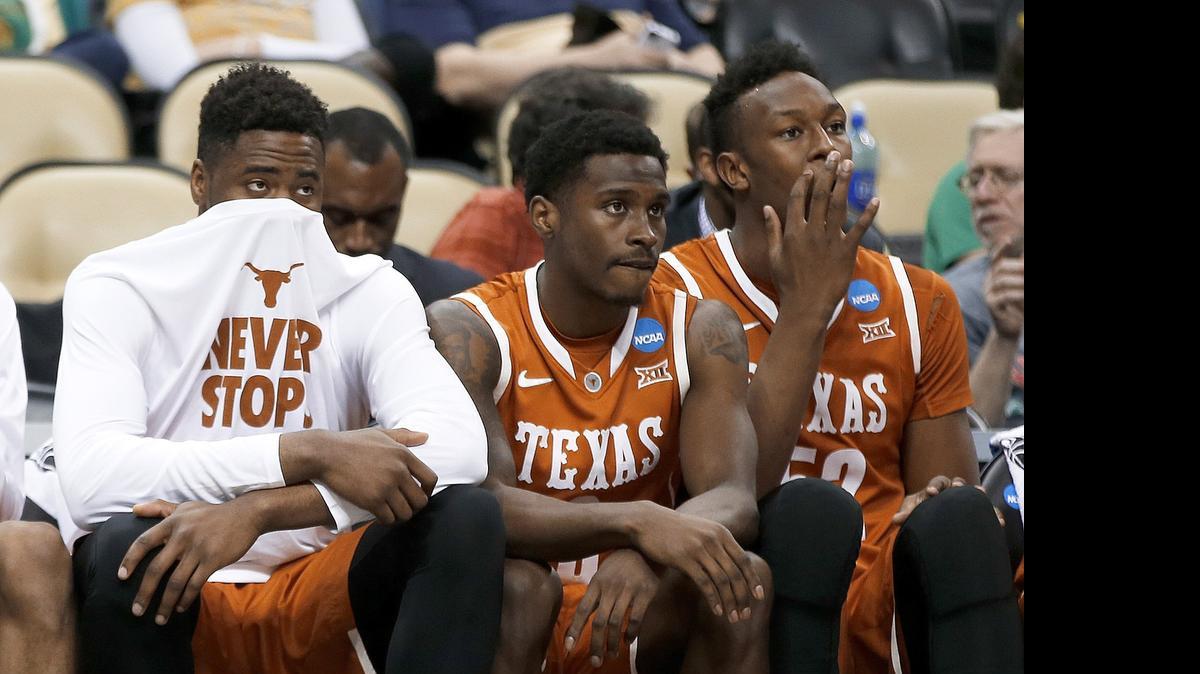 
Texas's Myles Turner, right, sits with other members of the team on the bench as they look on with time running out in the second half of an NCAA tournament loss to Butler.
