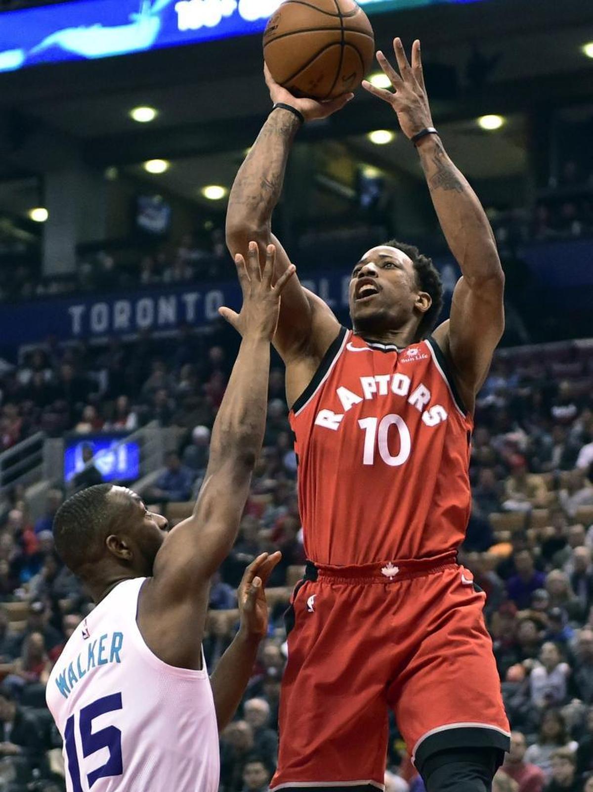 Toronto Raptors guard DeMar DeRozan (10) shoots over Charlotte Hornets guard Kemba Walker (15) during the first half.