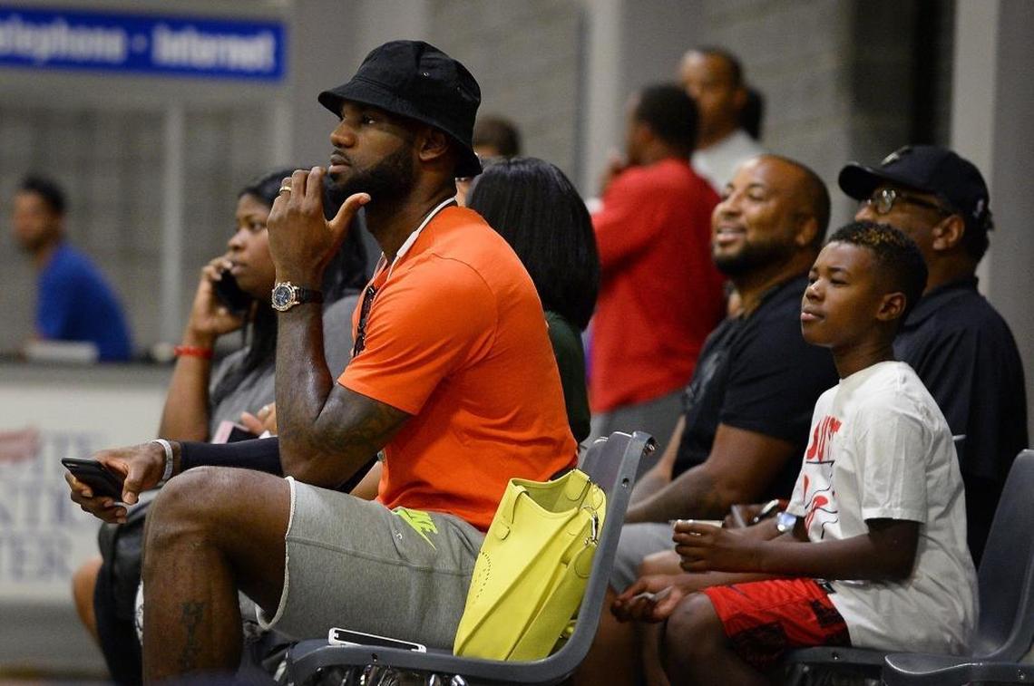 Cleveland Cavaliers star LeBron James sits courtside watching his son, LeBron Jr., and the North Coast Blue Chips (Ohio) at the Charlotte Convention Center on Friday.