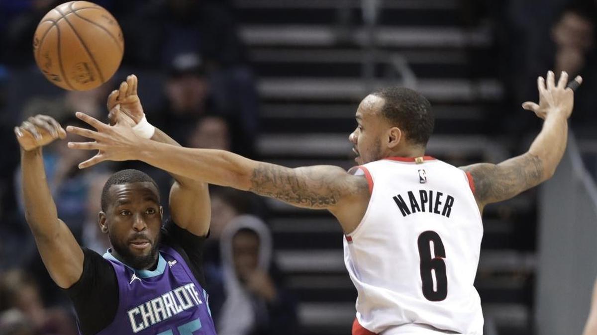 Charlotte Hornets' Kemba Walker (15) passes the ball past Portland Trail Blazers' Shabazz Napier (6) during the first half of Saturday’s game at Spectrum Center.