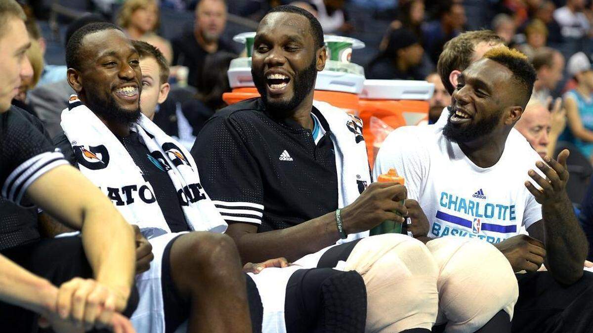 
Charlotte Hornets guard Kemba Walker, left, center Al Jefferson, center, and guard P.J. Hairston, right, laugh on the bench during first-half action against the New York Knicks on Saturday at Time Warner Cable Arena in Charlotte.
