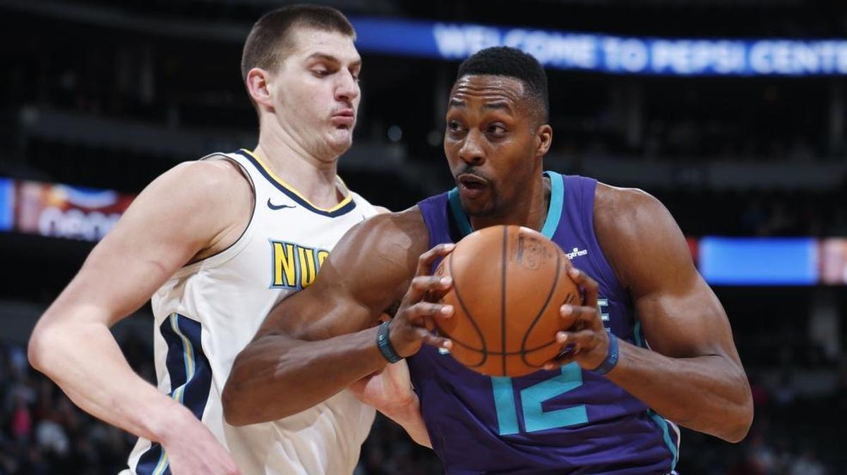 Charlotte Hornets center Dwight Howard (12) made all seven of his first-half shots in Monday’s road game against the Denver Nuggets and center Nikola Jokic.