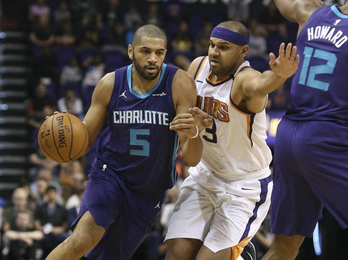 Charlotte Hornets guard Nicolas Batum (5) drives to the basket past the defense of Phoenix Suns' Jared Dudley (3) during Sunday’s game.