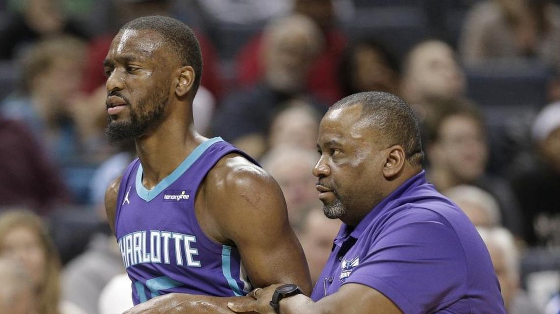 Charlotte Hornets' Kemba Walker (15) is helped off the court after being injured during the second half of Saturday’s home loss to the San Antonio Spurs. Walker returned to that game, but will not play Wednesday in Toronto versus the Raptors.