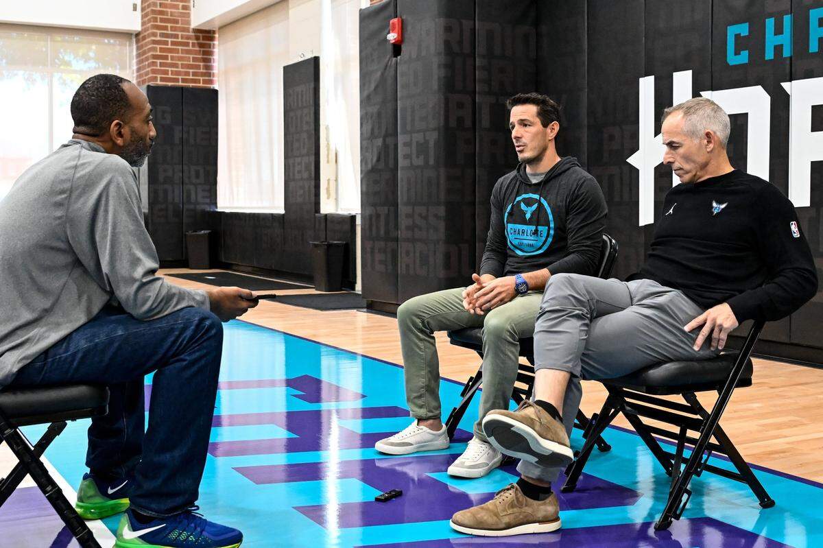 Charlotte Observer reporter Roderick Boone, left, interviews Charlotte Hornets owners Rick Schnall and Gabe Plotkin Saturday, Oct. 19, 2024, in Charlotte, N.C. (Charlotte Observer /Matt Kelley)