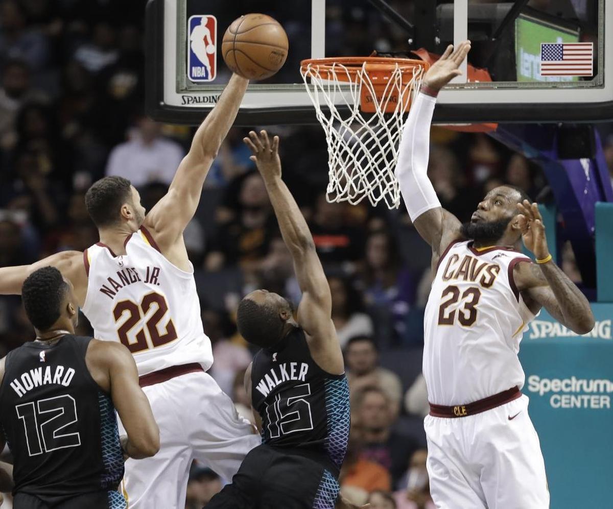 Charlotte Hornets' guard Kemba Walker (15) shoots between Cleveland Cavaliers' LeBron James (23) and Larry Nance Jr. (22) on his way to 21 points to set the franchise career scoring record.