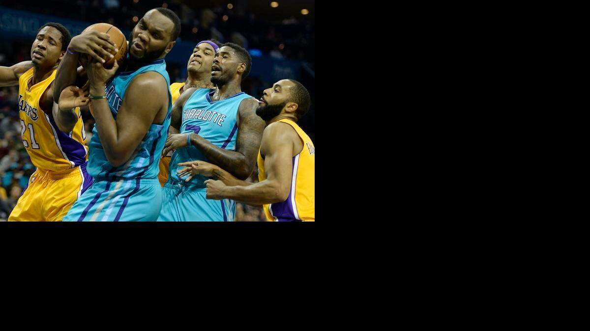 
The Charlotte Hornets' Al Jefferson (25) secures a rebound against the Los Angeles Lakers' Ed Davis (21) during the second half at the Time Warner Cable Arena in Charlotte, Tuesday, March 3, 2015. The Hornets won, 104-103.
