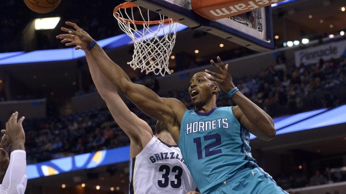 Charlotte Hornets center Dwight Howard (12) has his shot blocked by Memphis Grizzlies center Marc Gasol (33) in the first half of Monday night’s game in Memphis.