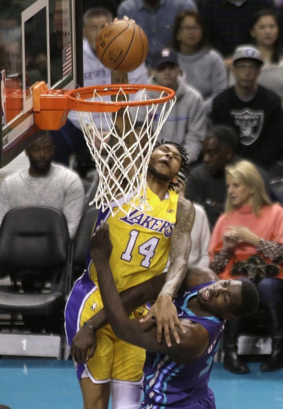 Brandon Ingram (14) dunks over Charlotte Hornets' Johnny O'Bryant III (8) during the first half of Saturday’s game.