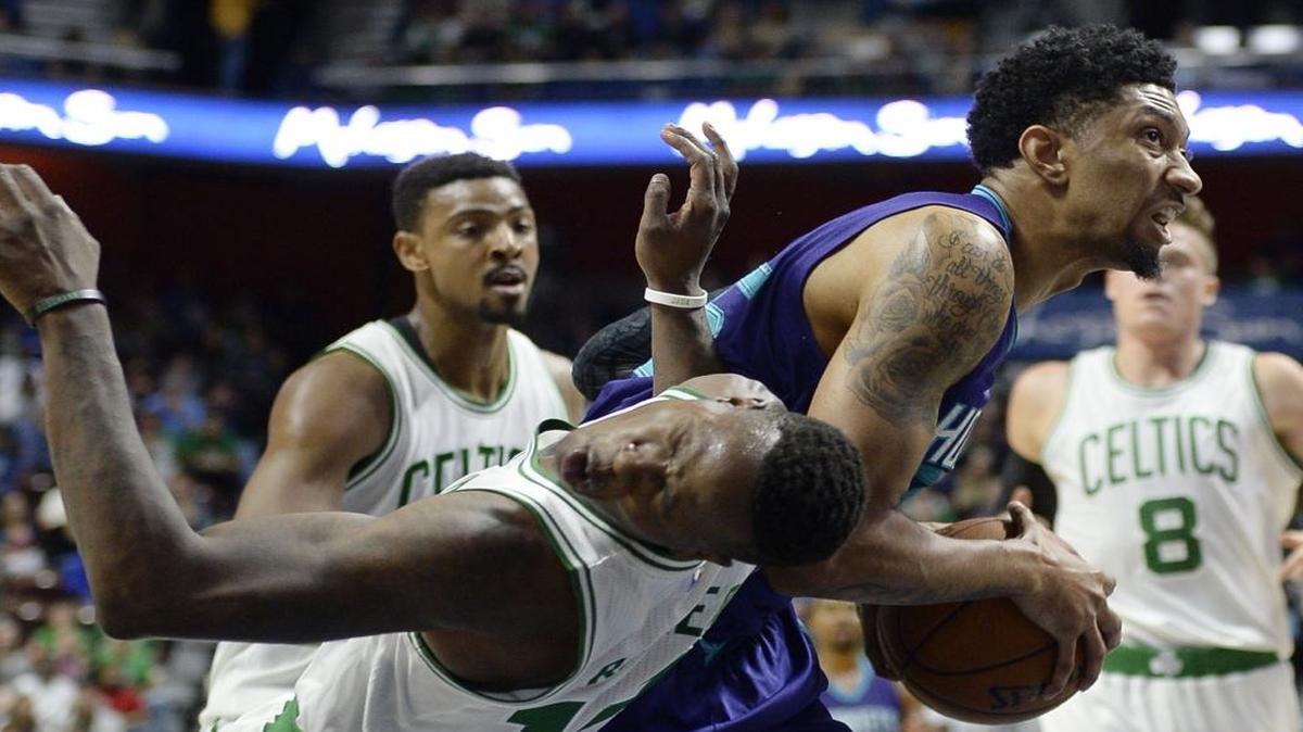 Boston Celtics' Terry Rozier, left falls to the floor after Charlotte Hornets' Christian Wood fouled him with an elbow to the face during the first half of Saturday’s NBA preseason game in Uncasville, Conn.