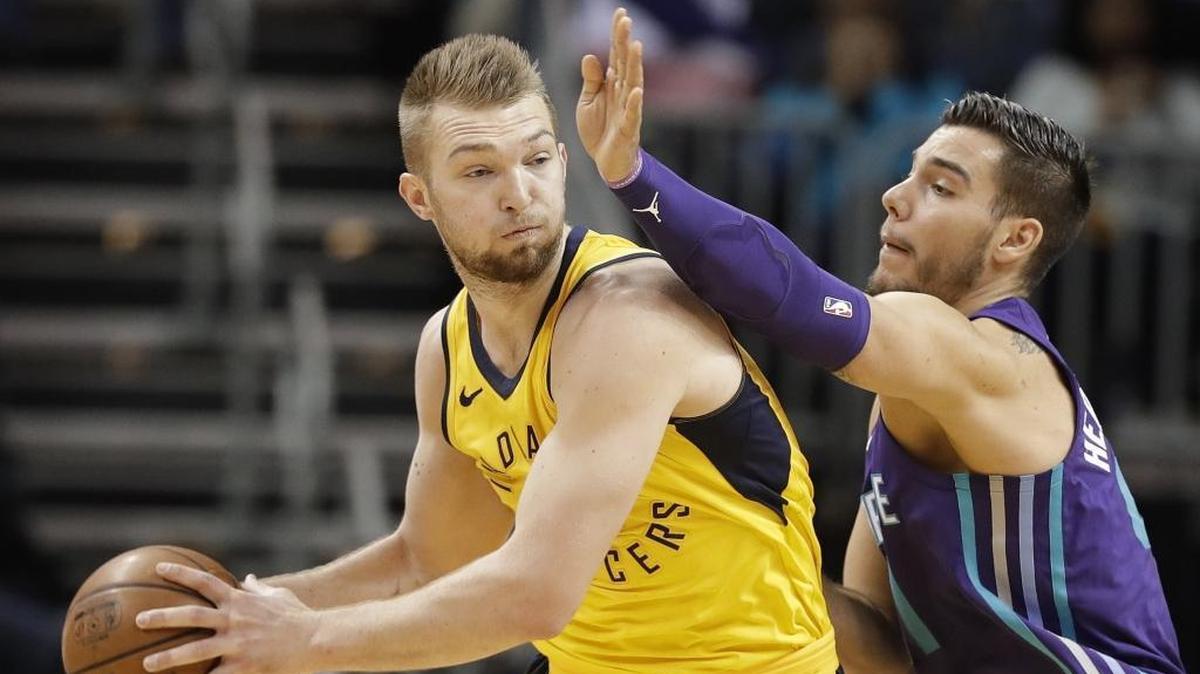 Indiana Pacers' Domantas Sabonis, left, drives against Charlotte Hornets' Willy Hernangomez, right, during the first half of Sunday’s game at Spectrum Center.
