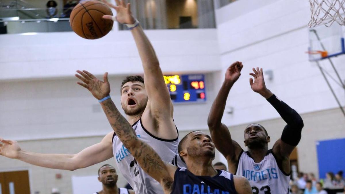 The Hornets’ Mike Tobey, center, said: “This is so fast for me with the 24-second shot clock. And adjusting to very different rules like three seconds in the lane on defense.”
