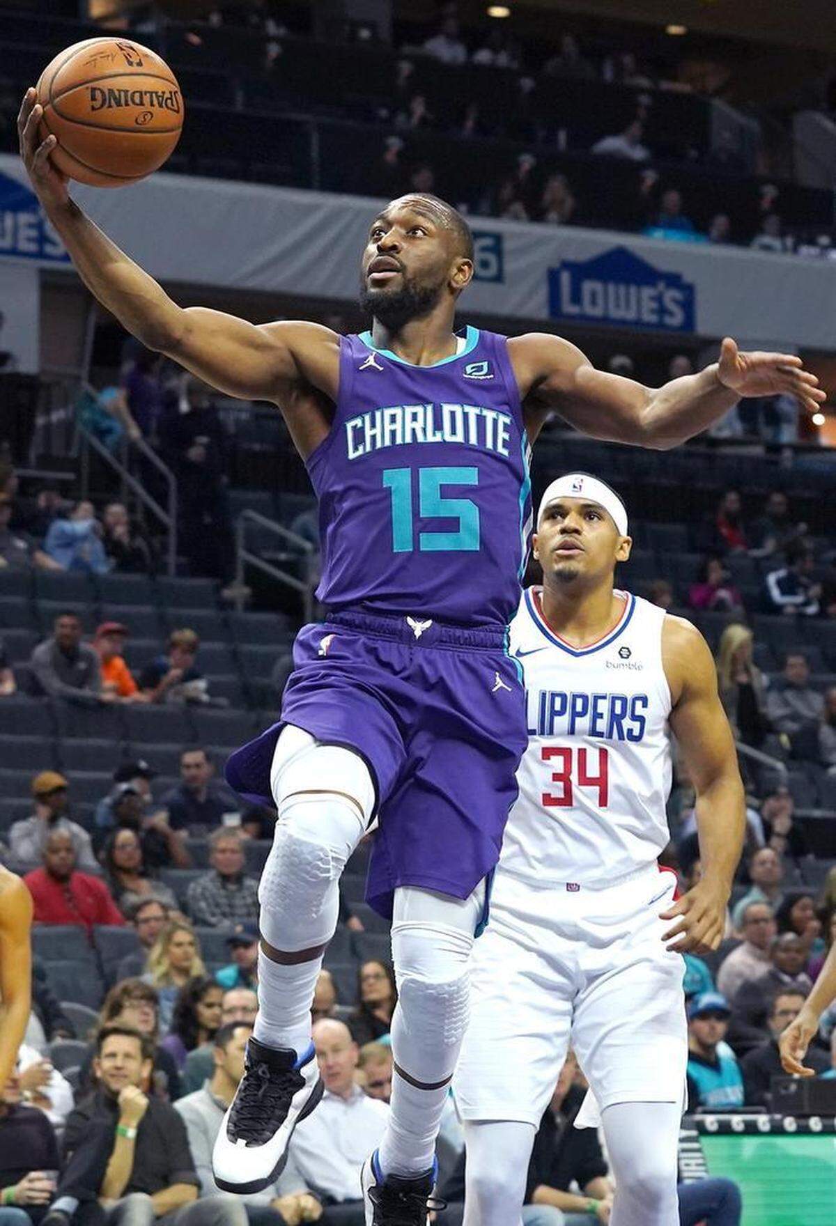 Charlotte Hornets guard Kemba Walker drives to the basket for two-points during first half action against the Los Angeles Clippers at Spectrum Center in Charlotte, NC on Tuesday, February 5, 2019. Clippers forward Tobias Harris, right, looks on.