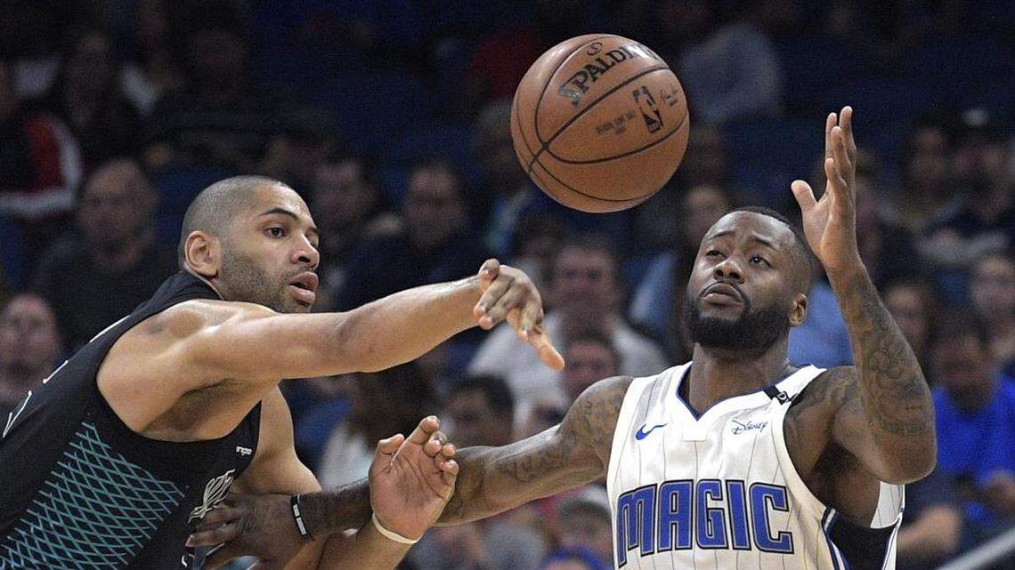 Charlotte Hornets guard Nicolas Batum, left, knocks the ball away from Orlando Magic forward Jonathon Simmons. The Hornets registered a season-high 14 steals in Wednesday’s 104-102 win at Orlando.