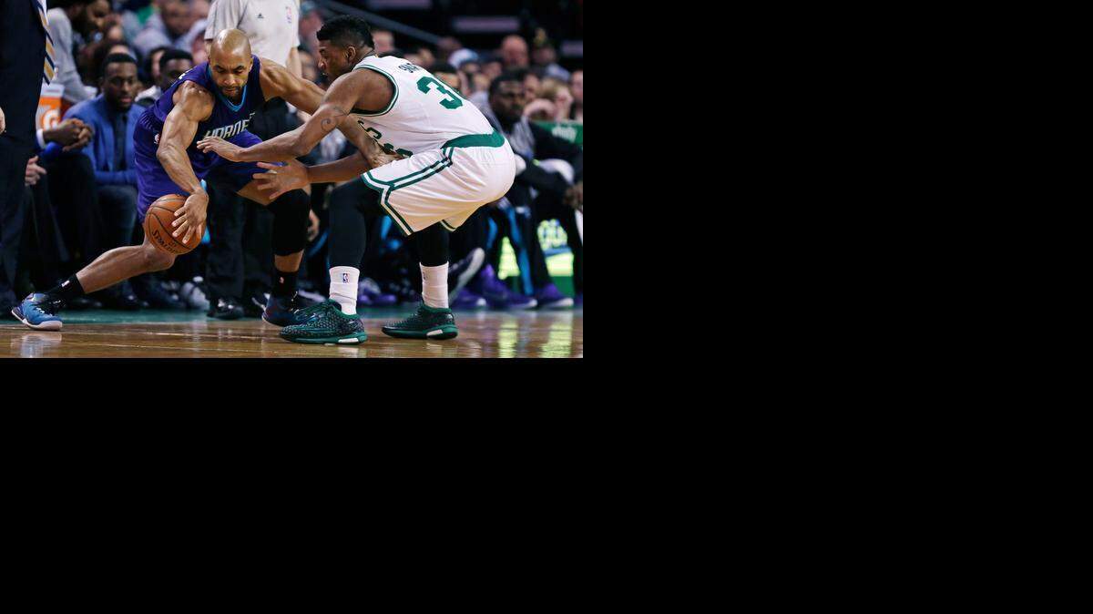 
Boston Celtics guard Marcus Smart (36) tries to trap Charlotte Hornets guard Gerald Henderson, left, during the first quarter of an NBA basketball game in Boston, Friday, Feb. 27, 2015. 
