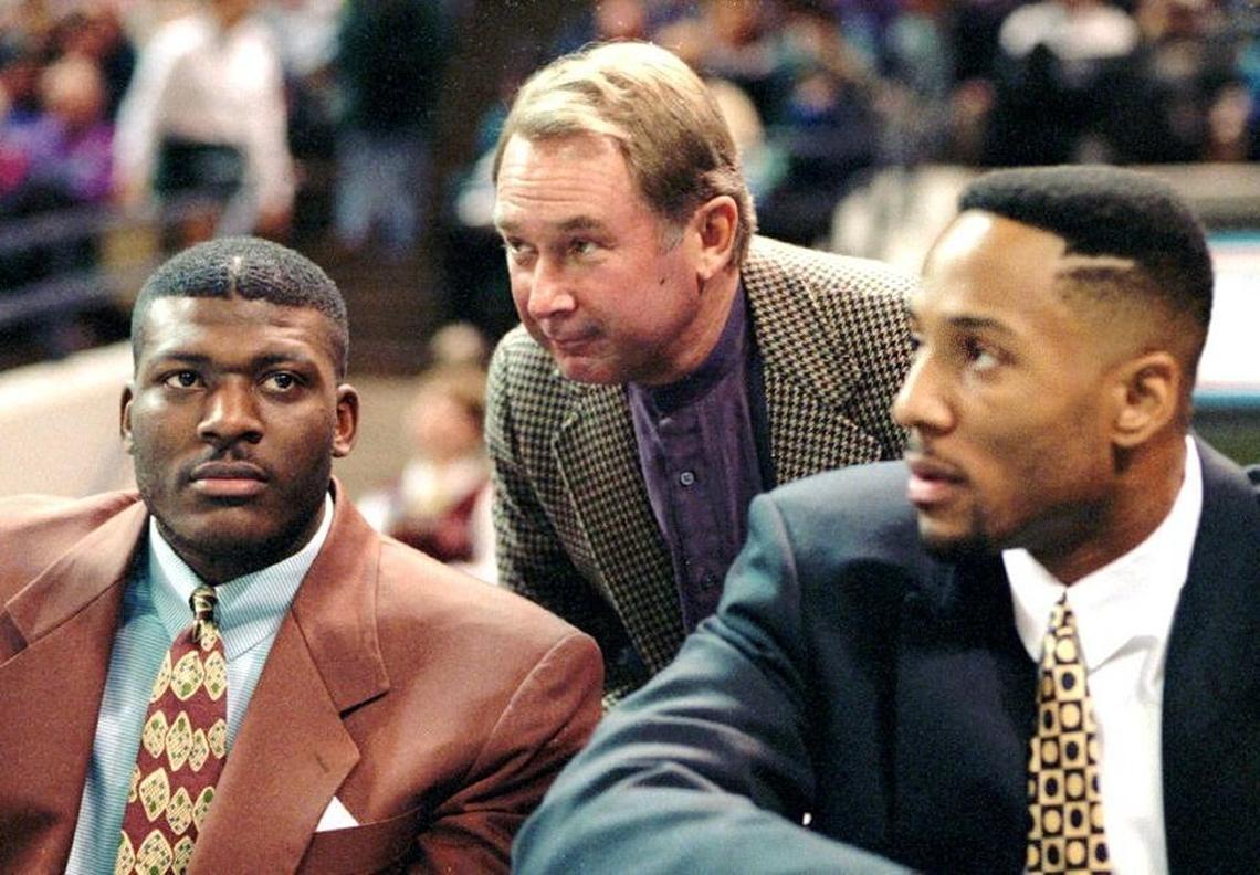 Former Charlotte Hornets owner George Shinn speaking with stars Larry Johnson (left) and Alonzo Mourning (right) in 1994.
