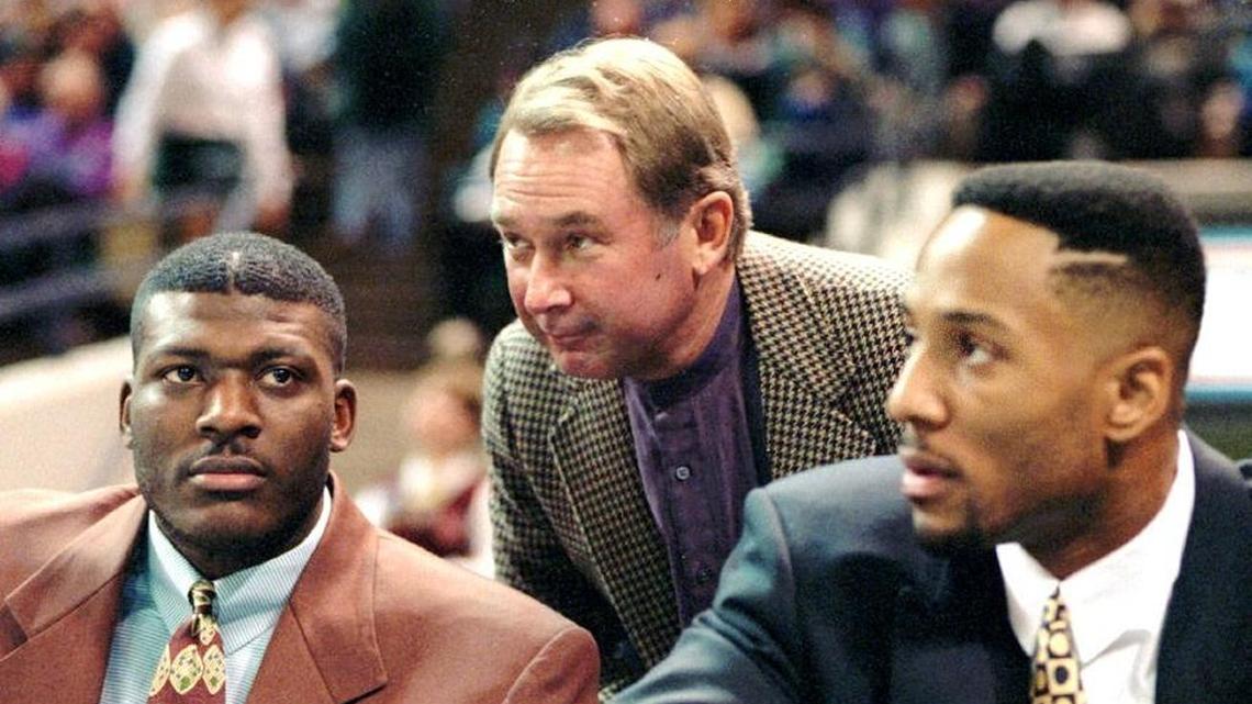 Former Charlotte Hornets owner George Shinn speaking with stars Larry Johnson (left) and Alonzo Mourning (right) in 1994.