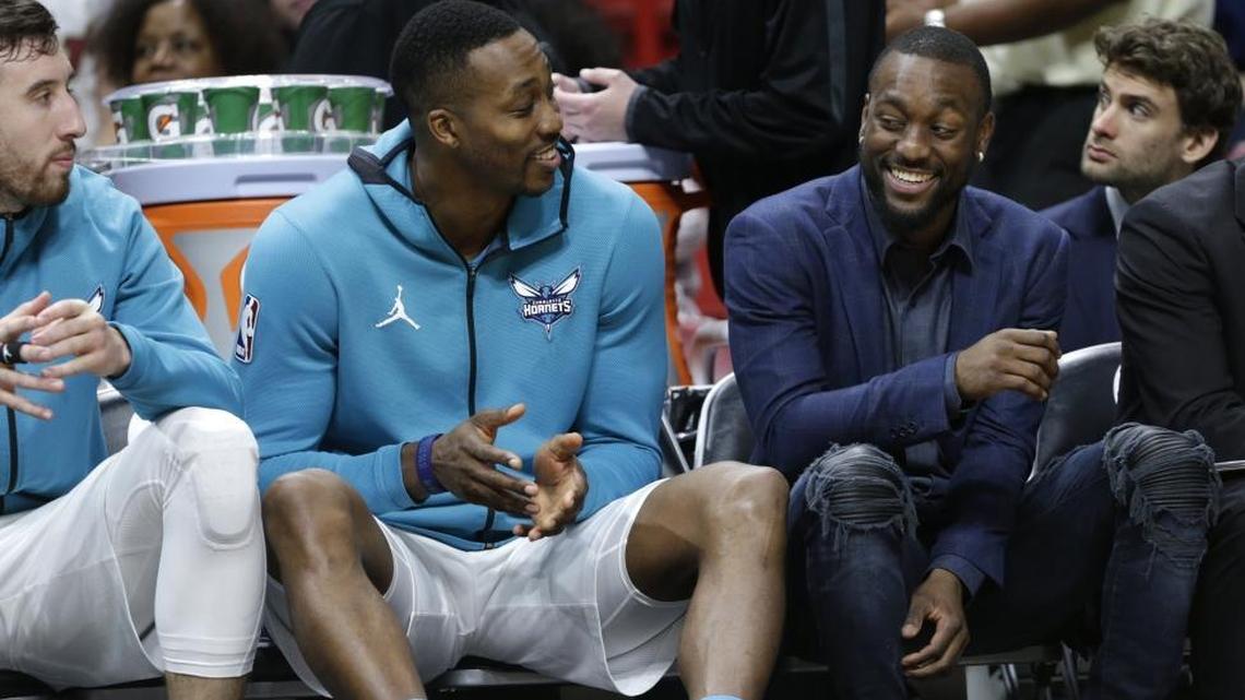Charlotte Hornets point guard Kemba Walker, right, had to watch the past two games in street clothes because of a contusion of his left shoulder. Walker fully practiced Sunday and expects to play Monday at home against the Orlando Magic.