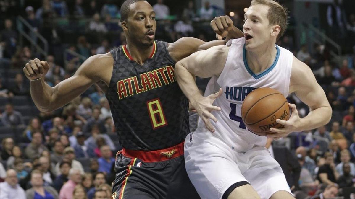 Charlotte Hornets center Cody Zeller (right) drives against the Atlanta Hawks’ Dwight Howard during an NBA game last November in Charlotte.