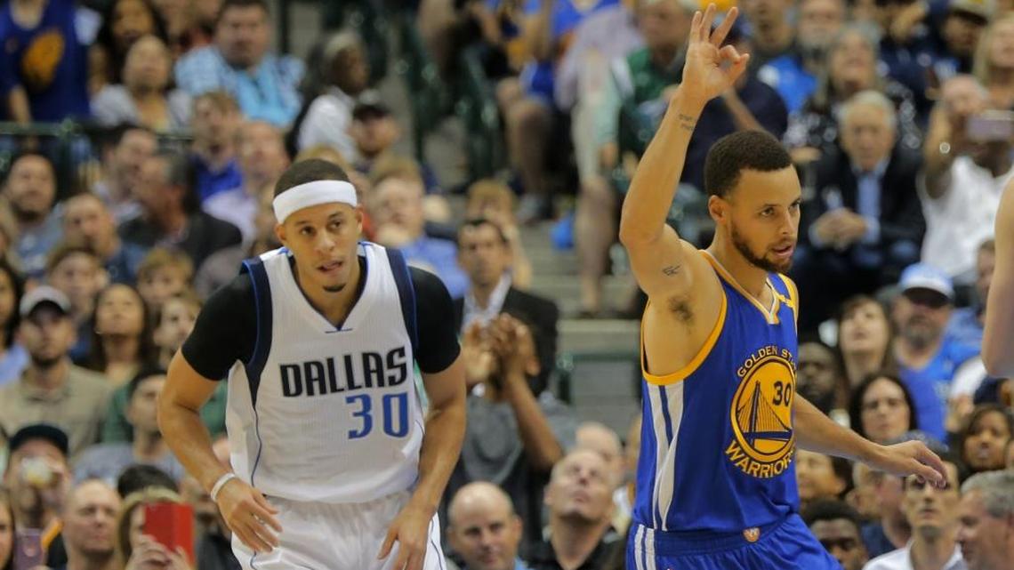 Dallas Mavericks guard Seth Curry (left), younger brother of Golden State Warriors superstar Stephen Curry (right), is shown in a game played last March in Dallas. Seth Curry has been sidelined this season with a leg injury.