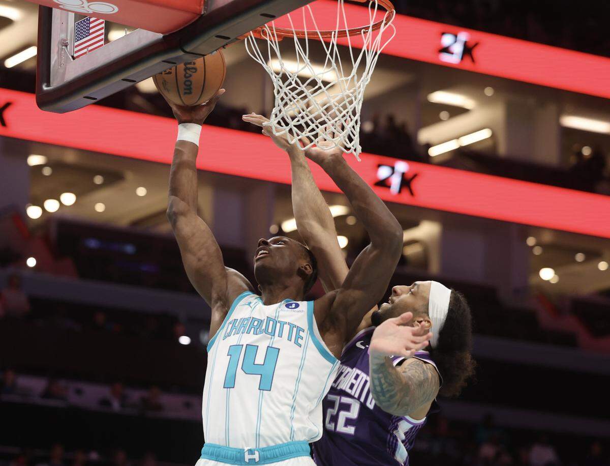 Charlotte Hornets forward Moussa Diabate goes up for the shot as Sacramento Kings Devin Carter attempts to block it during the game on Tuesday, March 24, 2026 at Spectrum Center in Charlotte.