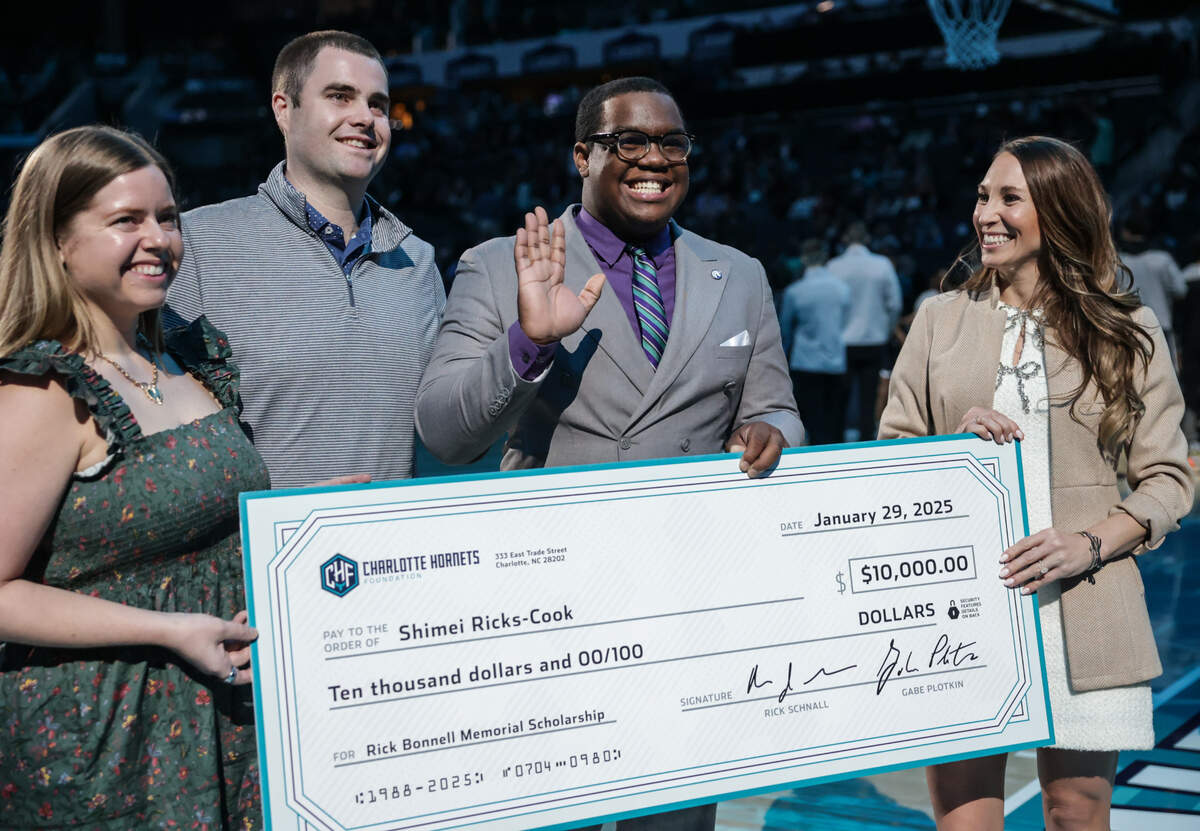 Charlotte Hornets give Fayettville State University junior Shimei Ricks-Cook, second from right, the 2025 Rick Bonnell Memorial Scholarship after the first quarter of the Hornets vs. Nets at Spectrum Center in Charlotte, NC on Wednesday, January 29, 2025. The scholarship awards $10,000 annual to a journalism student enrolled at a North Carolina college or university and honors the late great Hornets beat writer for The Charlotte Observer, Rick Bonnell — who covered the Hornets for the newspaper from its inaugural season through June 2021, when he passed away.