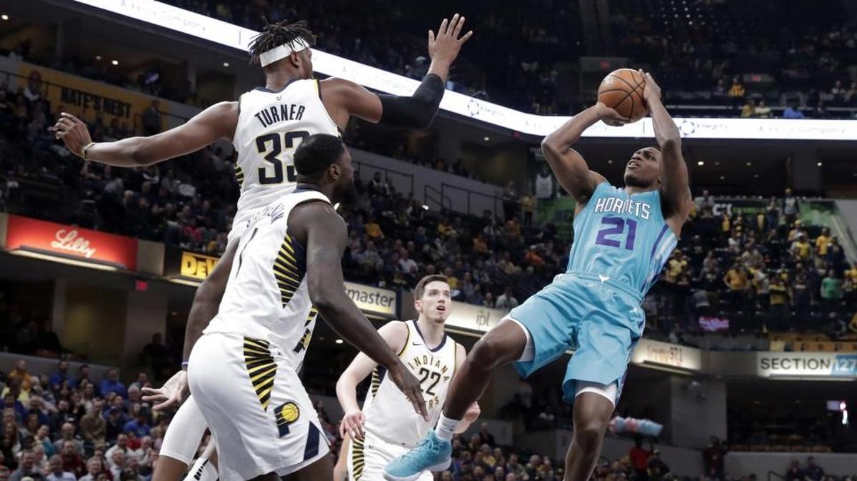 Charlotte Hornets guard Treveon Graham (21) jumps to shoot over Indiana Pacers center Myles Turner (33) during the first half Monday in Indianapolis.